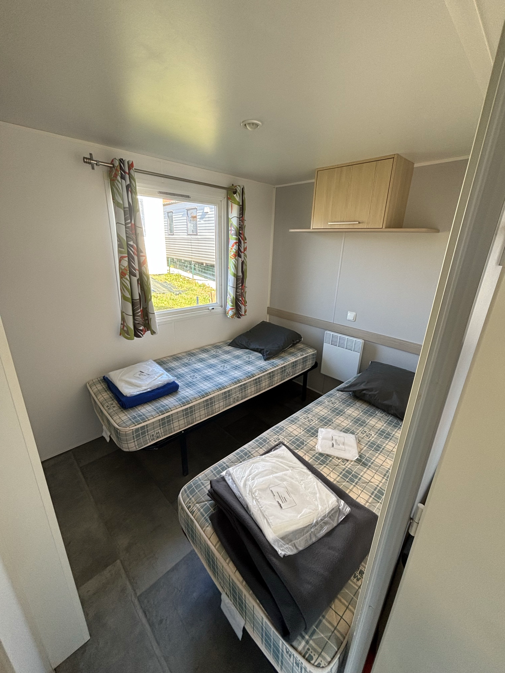 Photo d'une des chambres avec 2 lits simples du mobil-home Cygne